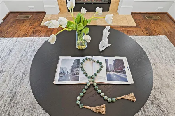a living room with a table chairs and a table