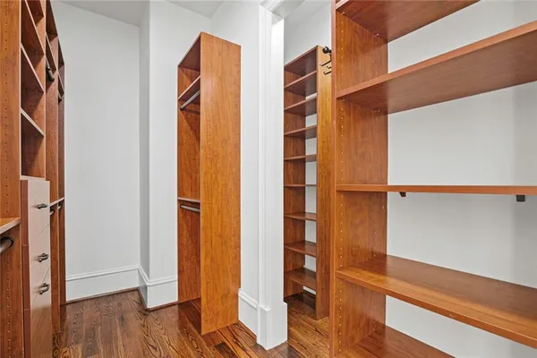 a view of a house next to a big yard and large trees