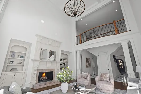 a living room with furniture and a chandelier