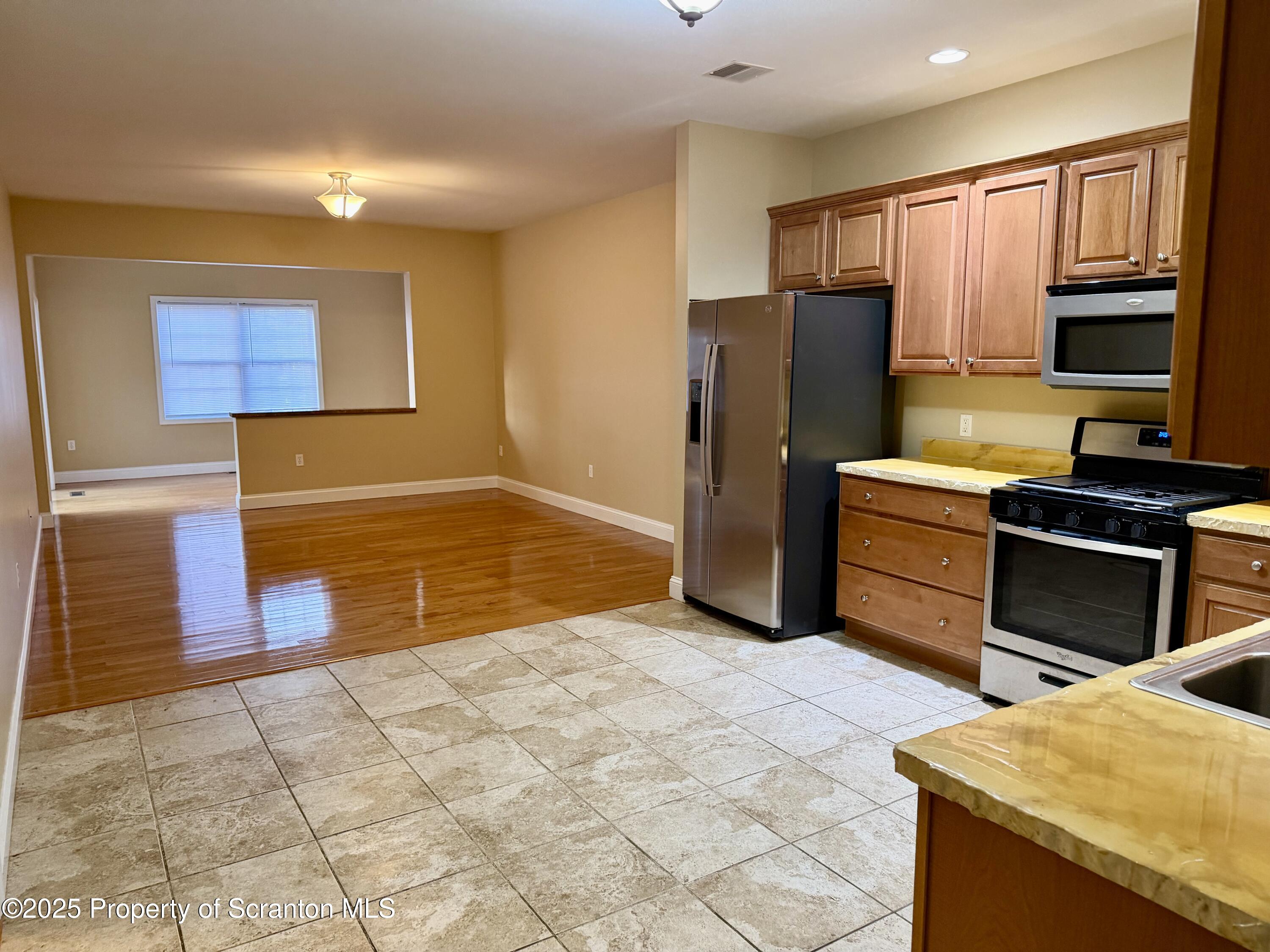 617 Arthur Avenue Scranton, PA 18510 - Photo 2 of 15 a kitchen with stainless steel appliances granite countertop a refrigerator a stove and a sink