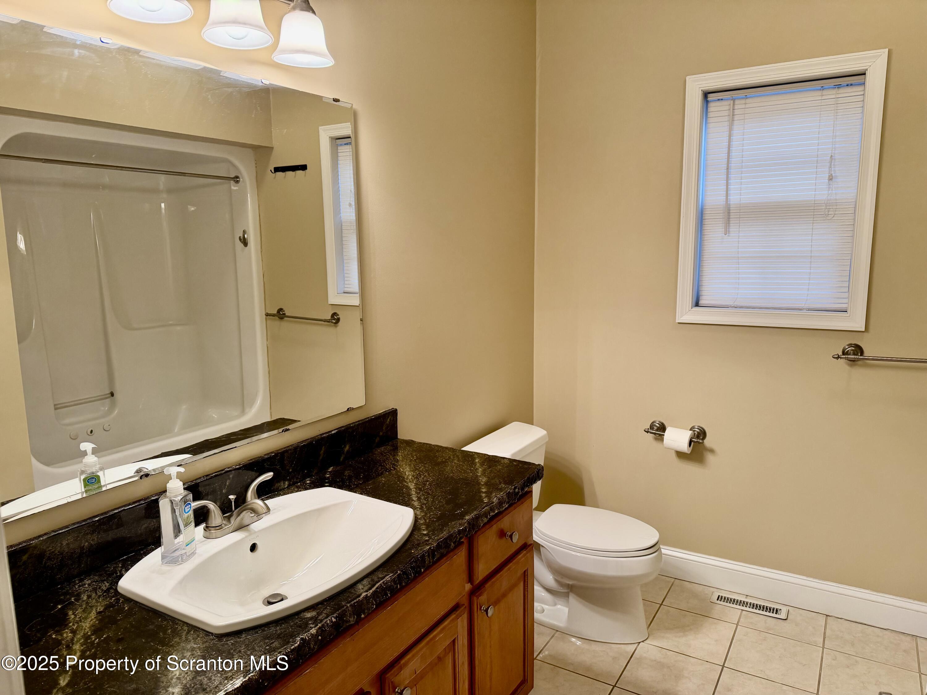617 Arthur Avenue Scranton, PA 18510 - Photo 7 of 15 a bathroom with a sink a toilet and shower