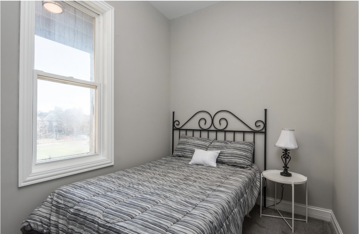 6607 South Ingleside Avenue Chicago, IL 60637 - Photo 20 of 28 a bedroom with a bed and a window