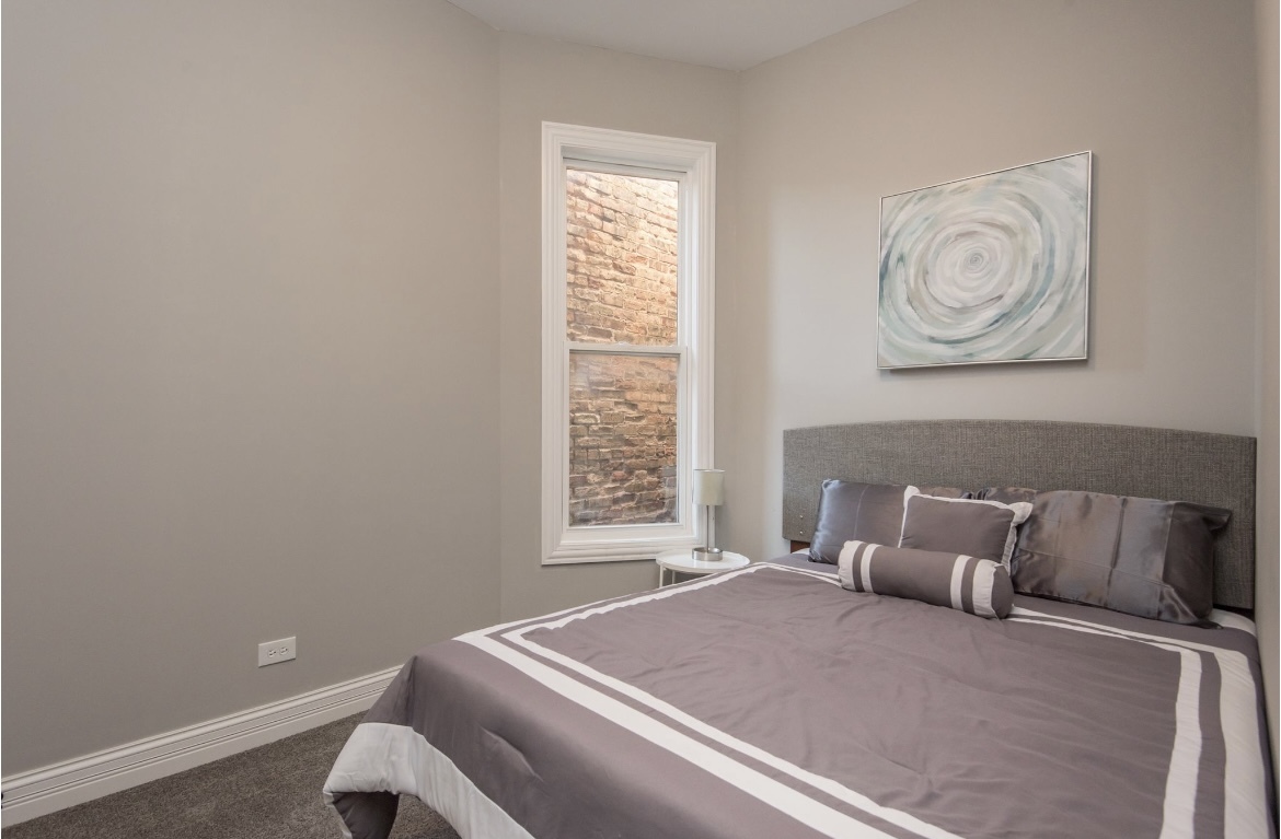 6607 South Ingleside Avenue Chicago, IL 60637 - Photo 21 of 28 a bedroom with a bed and a window