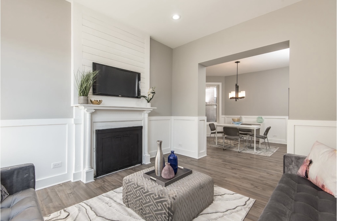 6607 South Ingleside Avenue Chicago, IL 60637 - Photo 3 of 28 a living room with furniture a fireplace and a flat screen tv