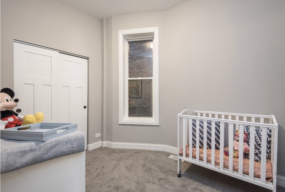 6607 South Ingleside Avenue Chicago, IL 60637 - Photo 9 of 28 a bedroom with a bed and a window