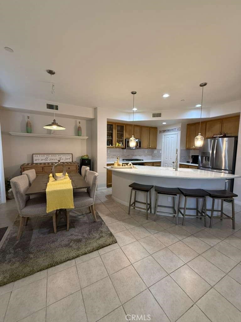 2931 Esperanza Way, Unit B Simi Valley, CA 93063 - Photo 9 of 49 a kitchen with kitchen island stainless steel appliances a table and chairs