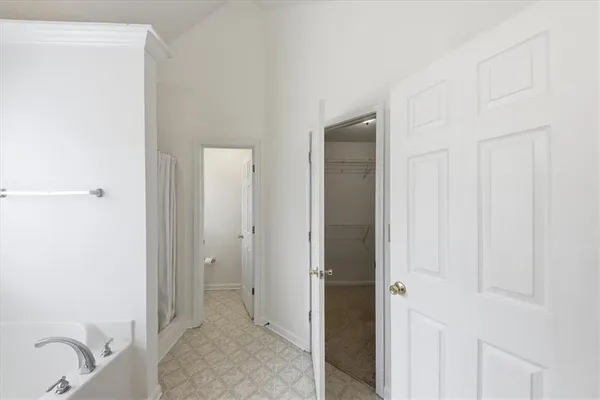 a bathroom with a tub sink and mirror