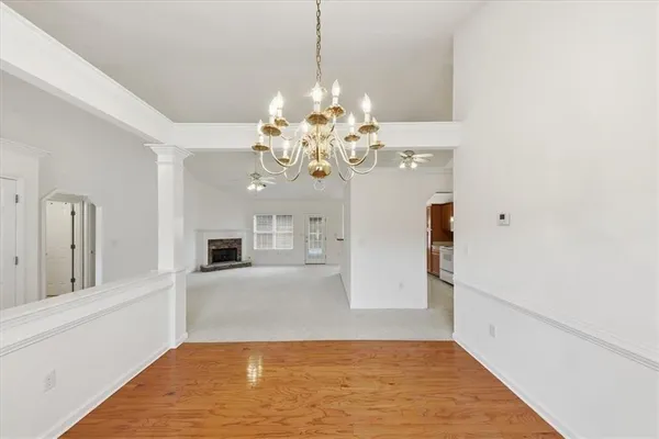 an empty room with windows and fireplace
