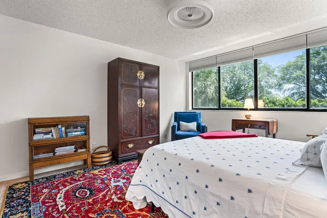a bedroom with a bed dresser and a window