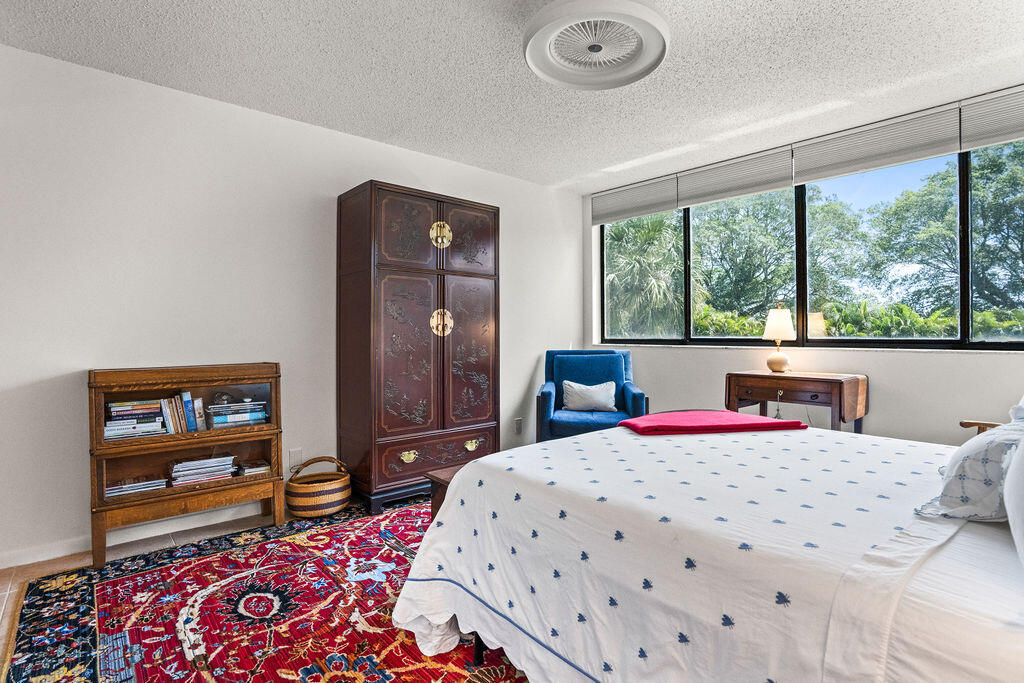 2520 Presidential Way, Unit 203 West Palm Beach, FL 33401 - Photo 11 of 27 a bedroom with a bed dresser and a window