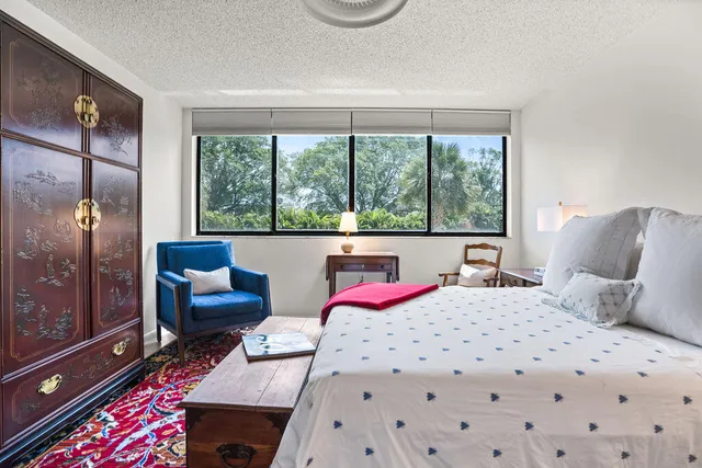 a bedroom with a bed couch and window