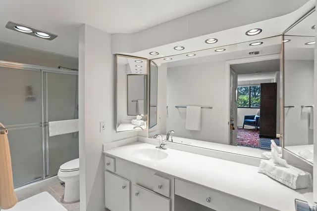 a spacious bathroom with a granite countertop sink mirror and toilet