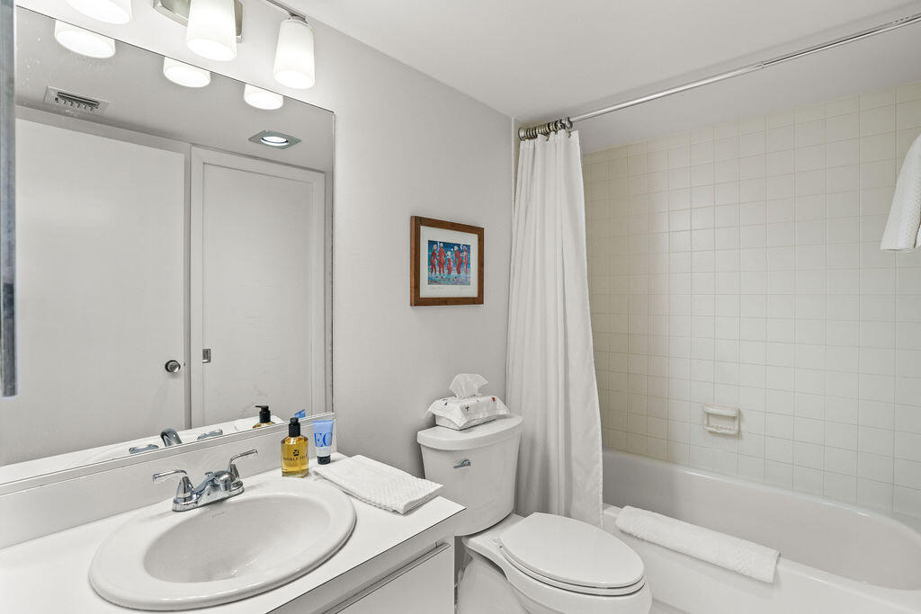 2520 Presidential Way, Unit 203 West Palm Beach, FL 33401 - Photo 17 of 27 a bathroom with a sink toilet and shower