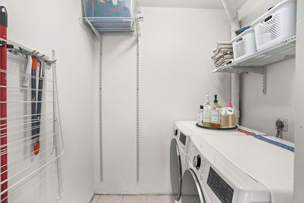 2520 Presidential Way, Unit 203 West Palm Beach, FL 33401 - Photo 18 of 27 a bathroom with a sink and cabinets