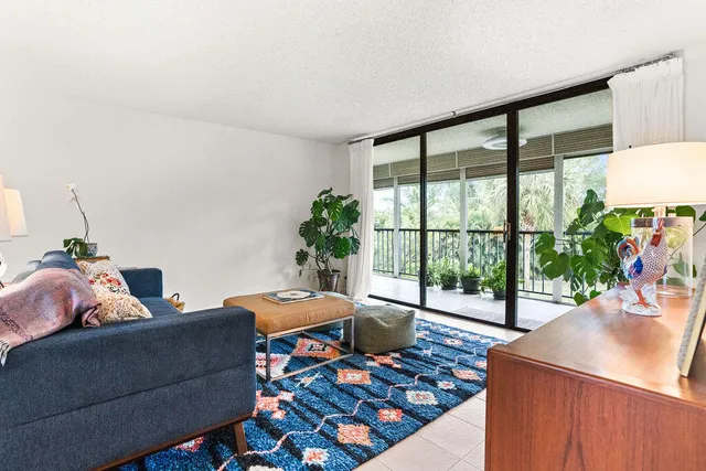 a living room with furniture and a potted plant