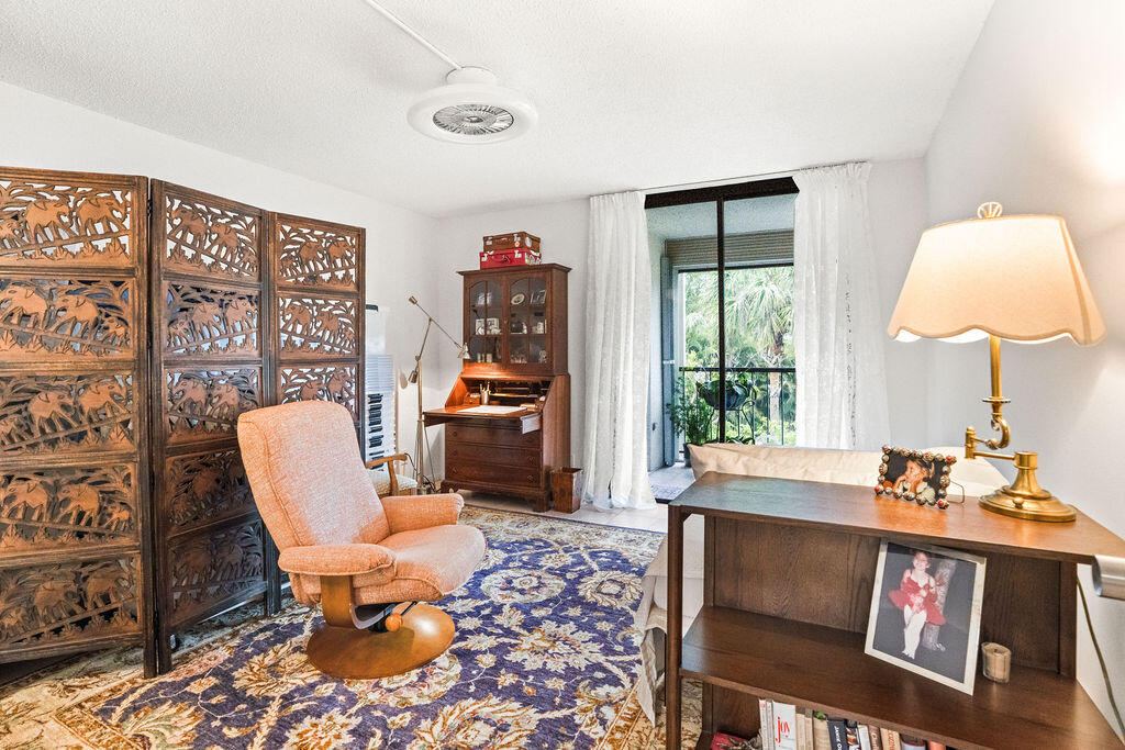 2520 Presidential Way, Unit 203 West Palm Beach, FL 33401 - Photo 22 of 27 a living room with furniture and a window