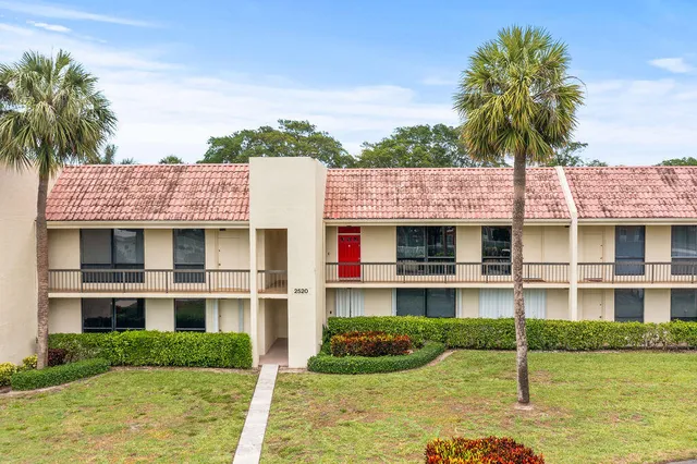 a view of a house with a garden and plants