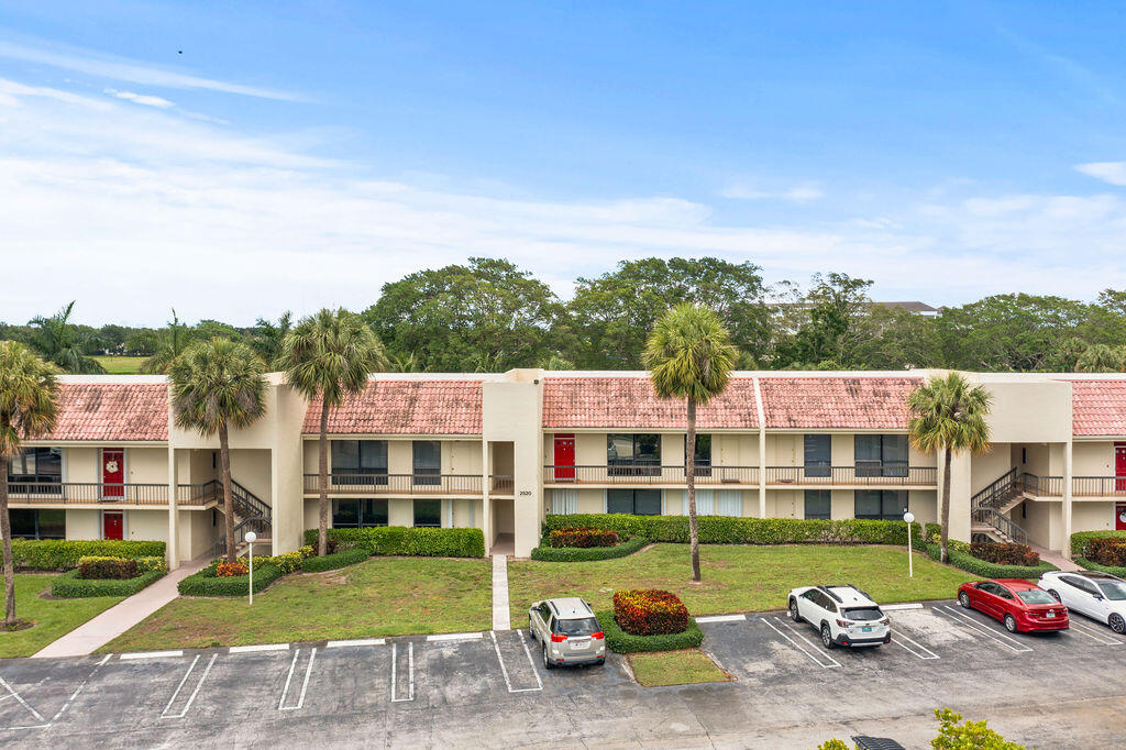 2520 Presidential Way, Unit 203 West Palm Beach, FL 33401 - Photo 26 of 27 a view of parked cars in front of building