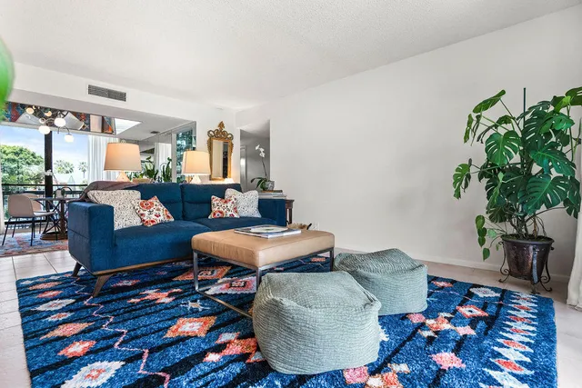 a living room with furniture and a potted plant