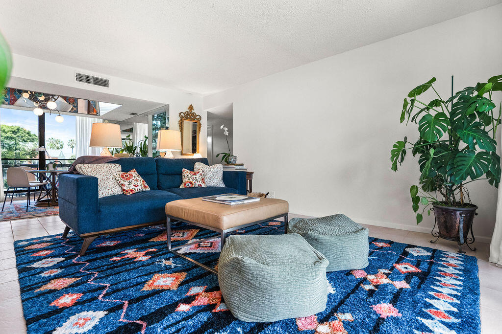 2520 Presidential Way, Unit 203 West Palm Beach, FL 33401 - Photo 3 of 27 a living room with furniture and a potted plant