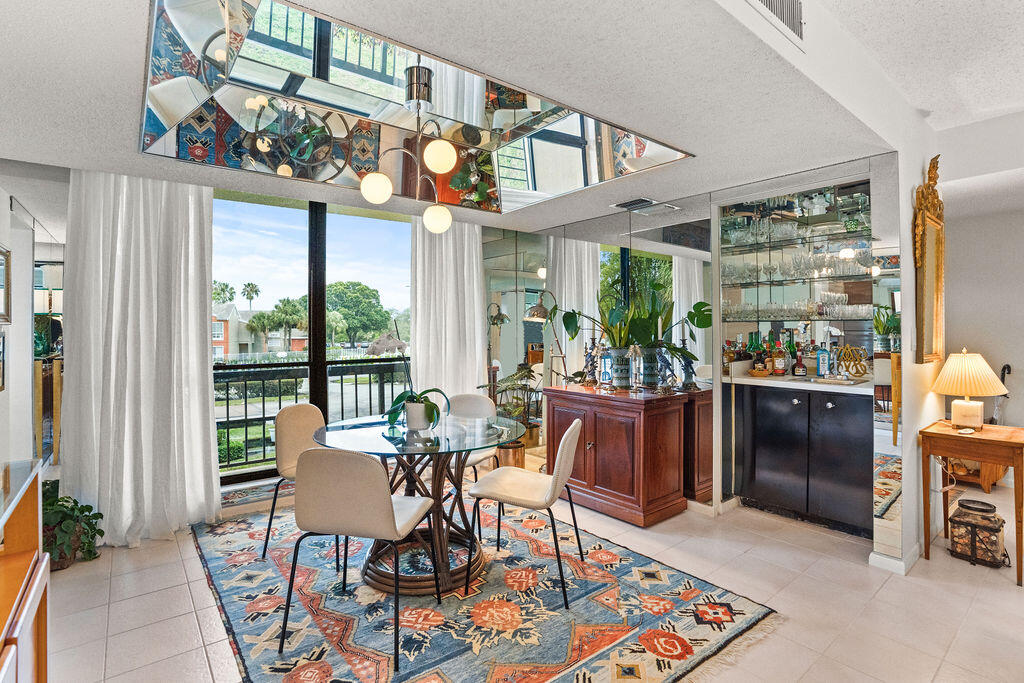 2520 Presidential Way, Unit 203 West Palm Beach, FL 33401 - Photo 4 of 27 a view of a dining room with furniture window and outdoor kitchen