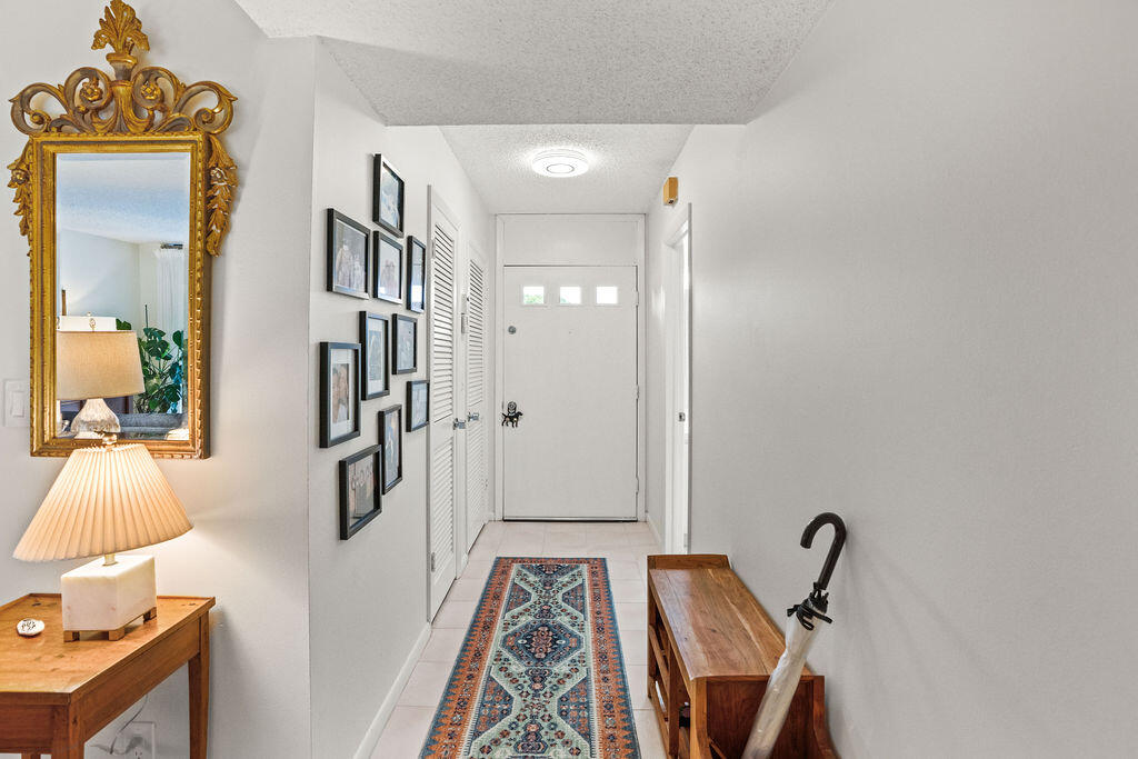 2520 Presidential Way, Unit 203 West Palm Beach, FL 33401 - Photo 6 of 27 a bathroom with a bathtub and a shower