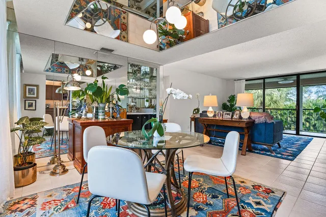 a view of a dining room with furniture a rug and wooden floor