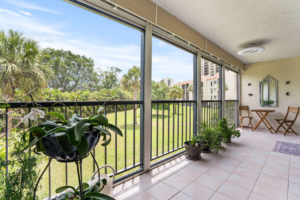 2520 Presidential Way, Unit 203 West Palm Beach, FL 33401 - Photo 9 of 27 a view of a chairs and table in a balcony