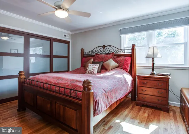 a bedroom with a bed and large window