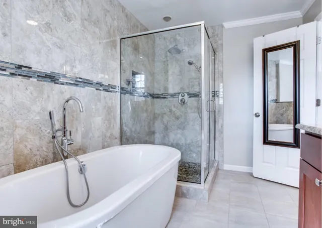 a bathroom with a granite countertop bathtub shower and vanity