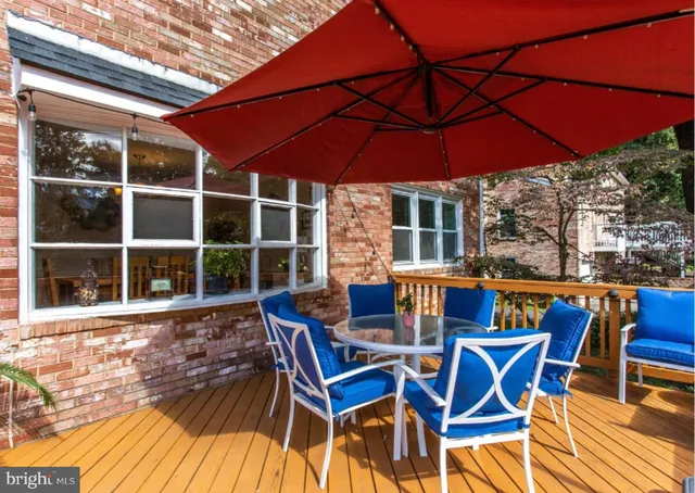 a blue swimming pool with outdoor seating