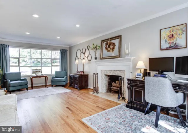 a living room with furniture a fireplace and a large window