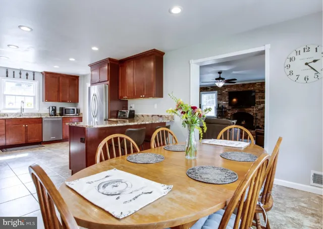 a kitchen with dining table and chairs