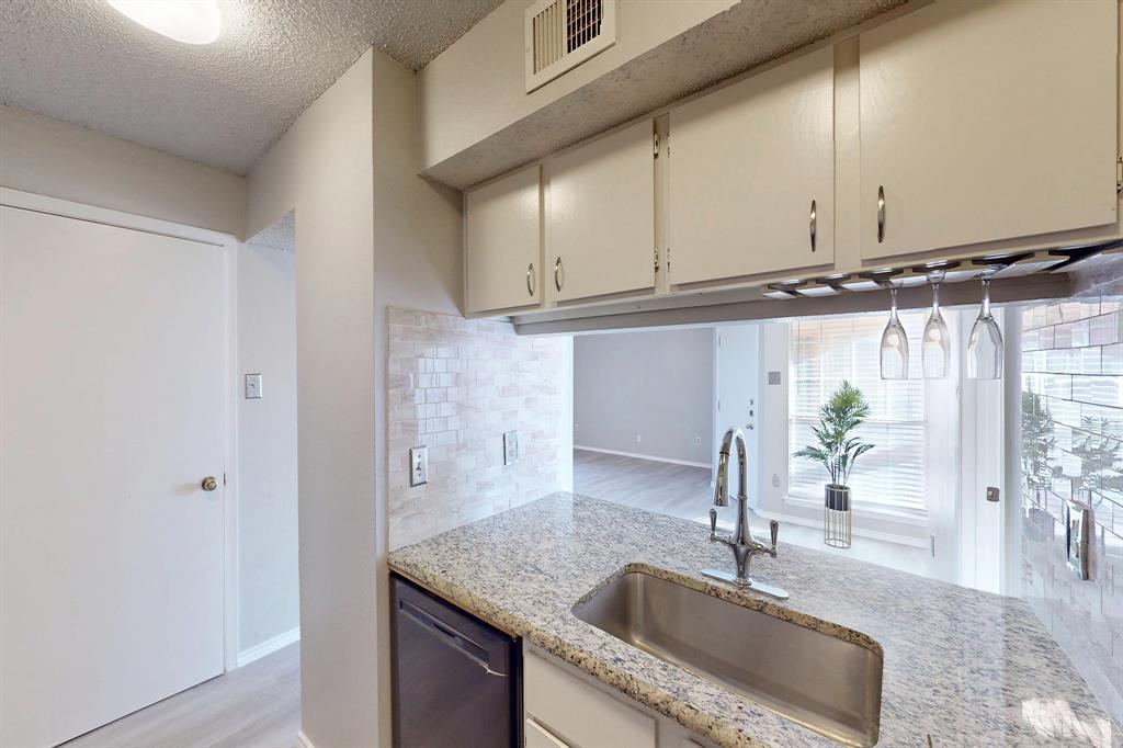 12484 Abrams Road, Unit 2121 Dallas, TX 75243 - Photo 12 of 27 a kitchen with granite countertop a sink and a window