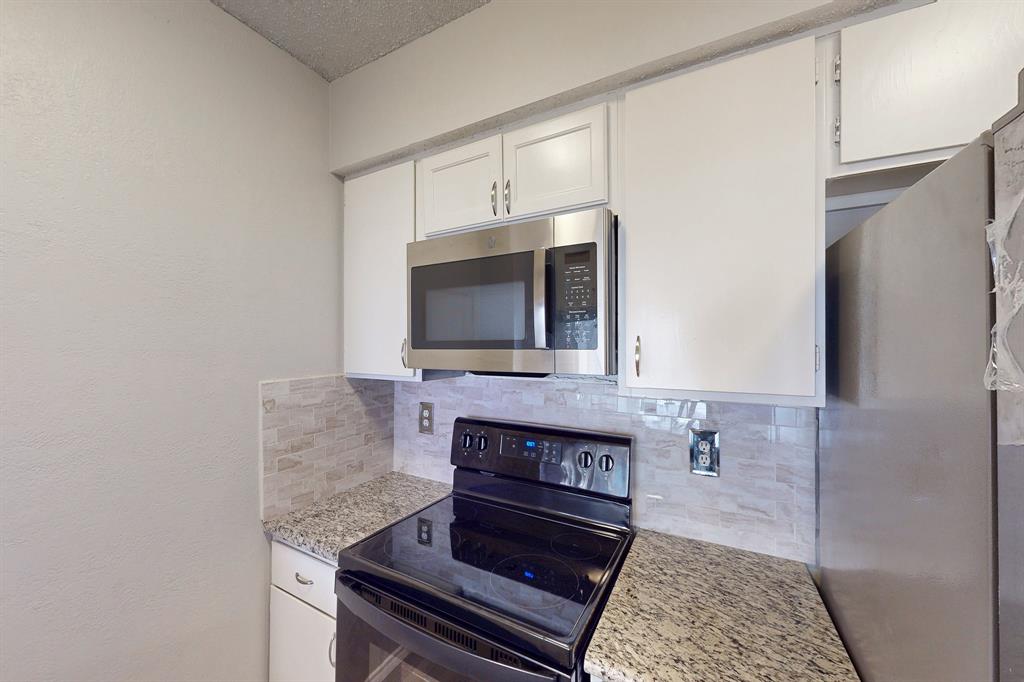 12484 Abrams Road, Unit 2121 Dallas, TX 75243 - Photo 13 of 27 a living room with a fireplace and a rug