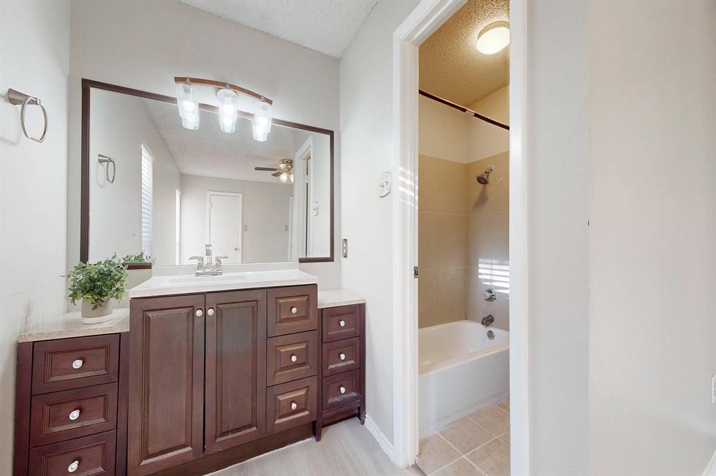 12484 Abrams Road, Unit 2121 Dallas, TX 75243 - Photo 18 of 27 a spacious bathroom with a granite countertop sink mirror and a bathtub