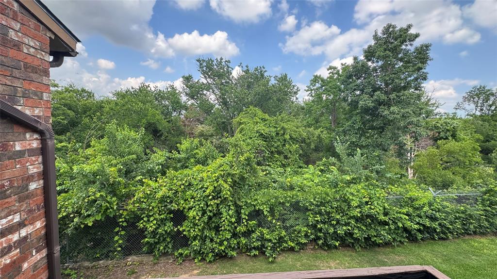 12484 Abrams Road, Unit 2121 Dallas, TX 75243 - Photo 25 of 27 a view of a yard with plants and a bench