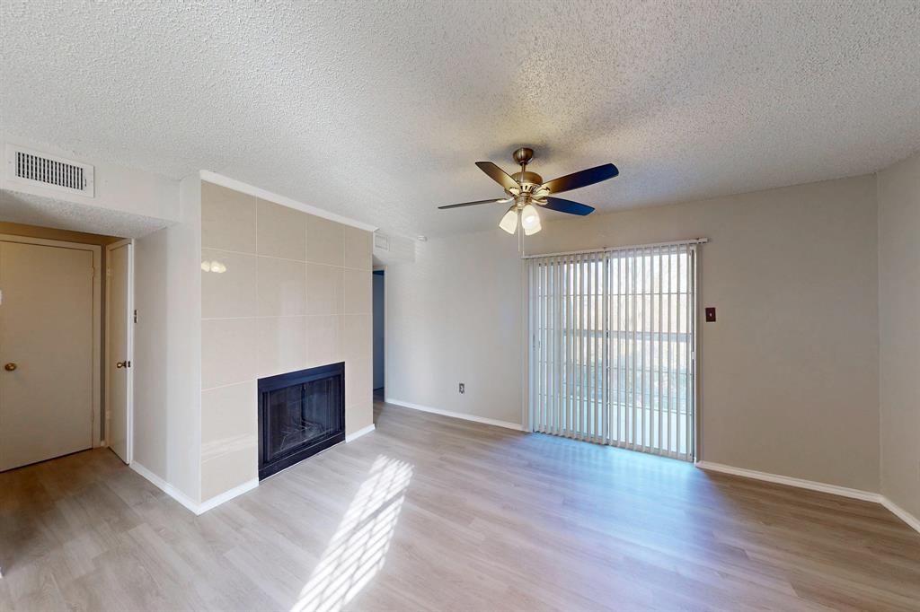 12484 Abrams Road, Unit 2121 Dallas, TX 75243 - Photo 4 of 27 a view of an empty room with window and wooden floor