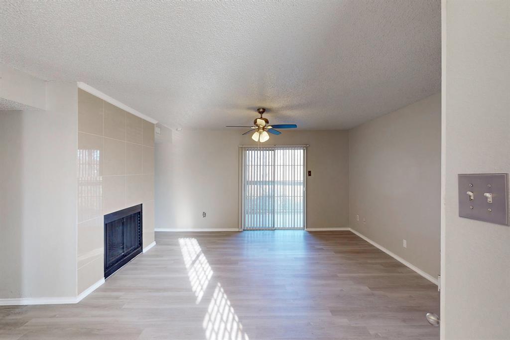 12484 Abrams Road, Unit 2121 Dallas, TX 75243 - Photo 6 of 27 wooden floor in an empty room with a window