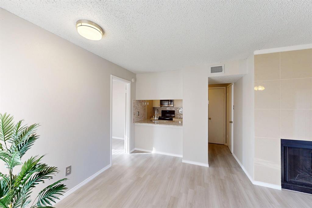 12484 Abrams Road, Unit 2121 Dallas, TX 75243 - Photo 7 of 27 a view of a living room a wooden floor and a potted plant