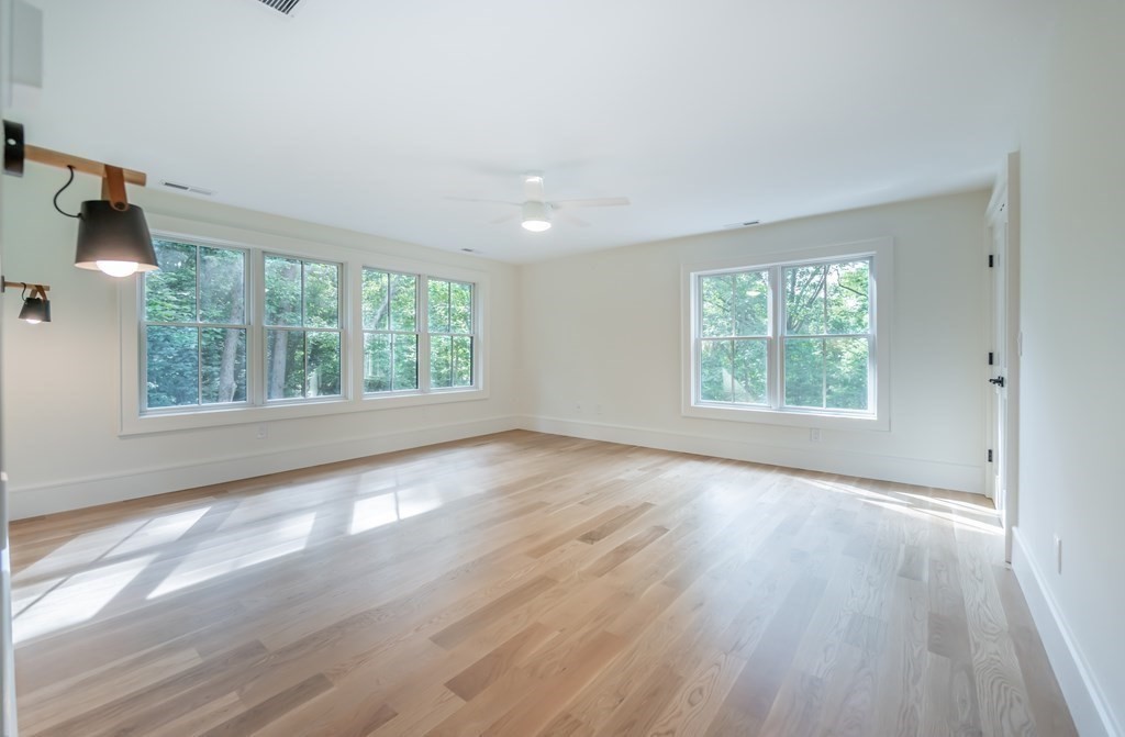 5 Tucker Road Andover, MA 01810 - Photo 20 of 42 an empty room with wooden floor and windows