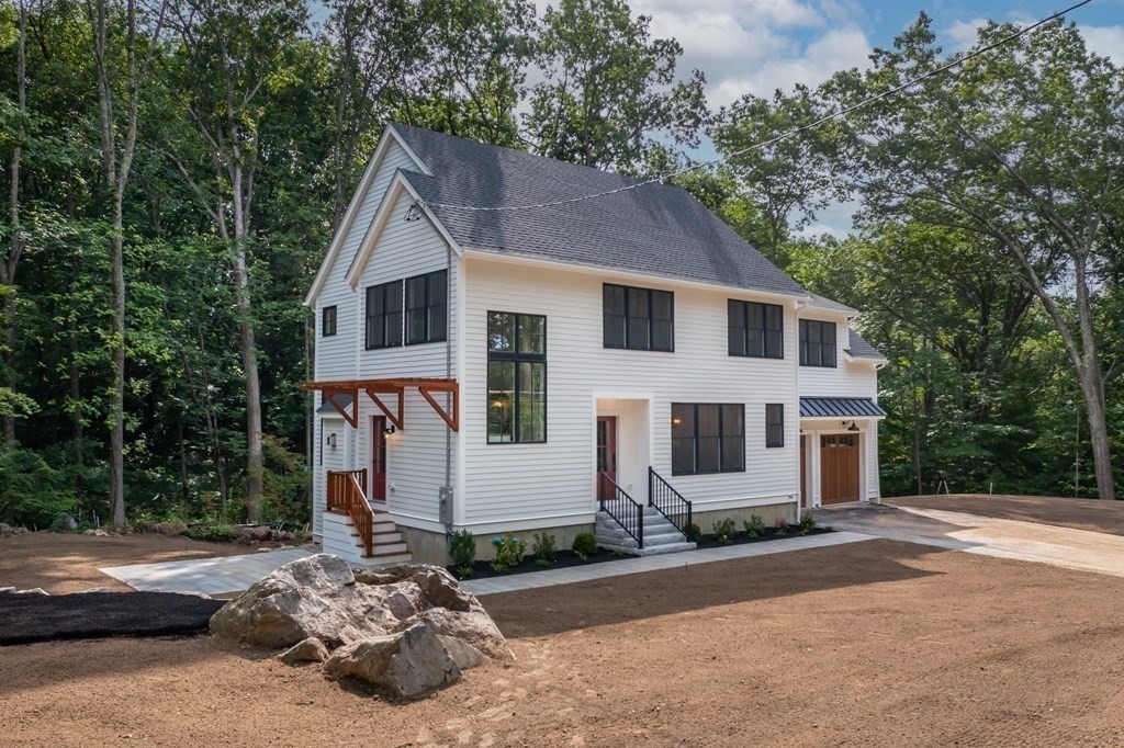 5 Tucker Road Andover, MA 01810 - Photo 2 of 42 a front view of a house with a yard