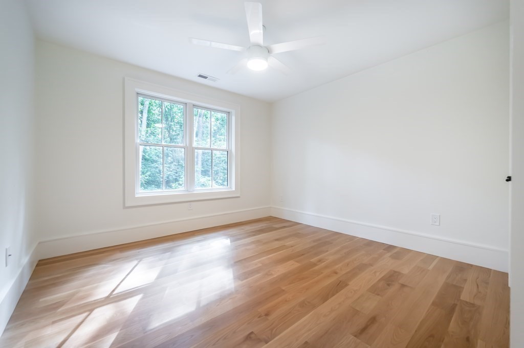 5 Tucker Road Andover, MA 01810 - Photo 32 of 42 an empty room with wooden floor and windows