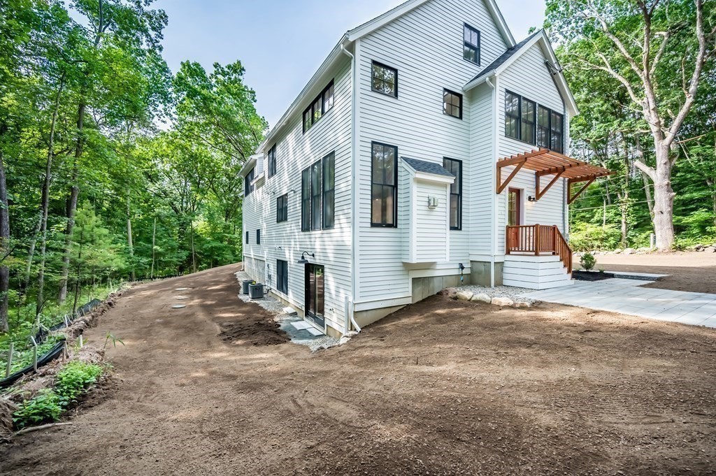 5 Tucker Road Andover, MA 01810 - Photo 38 of 42 a view of a white house with large windows and a large tree
