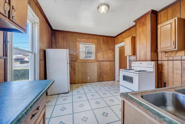 a kitchen with refrigerator cabinets and wooden floor