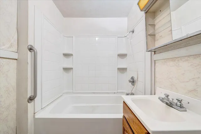 a bathroom with a bathtub and a sink