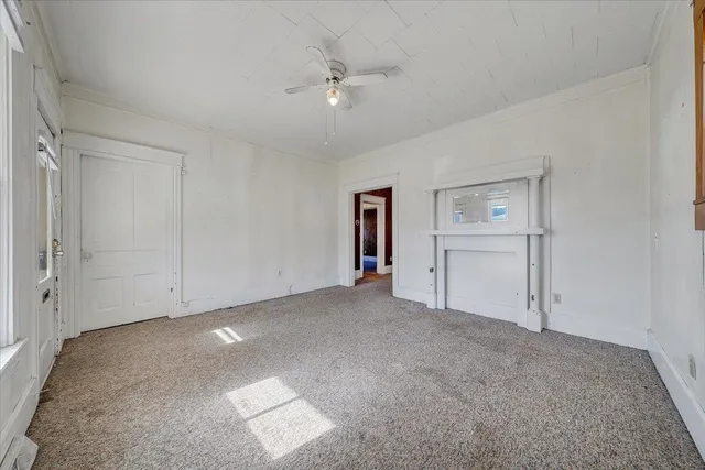 an empty room with closet and windows