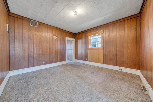 an empty room with windows and closet