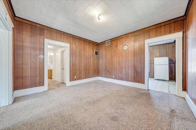 an empty room with closet and wooden floor