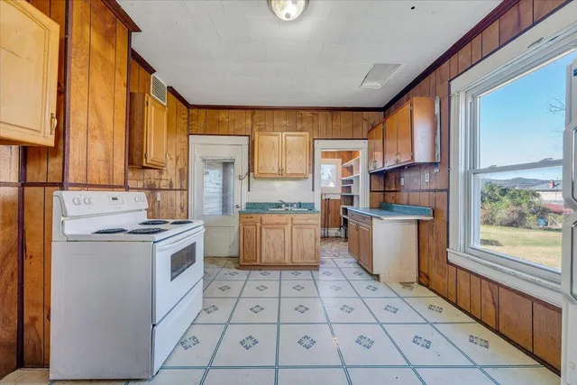 a kitchen with a stove a sink dishwasher and a refrigerator